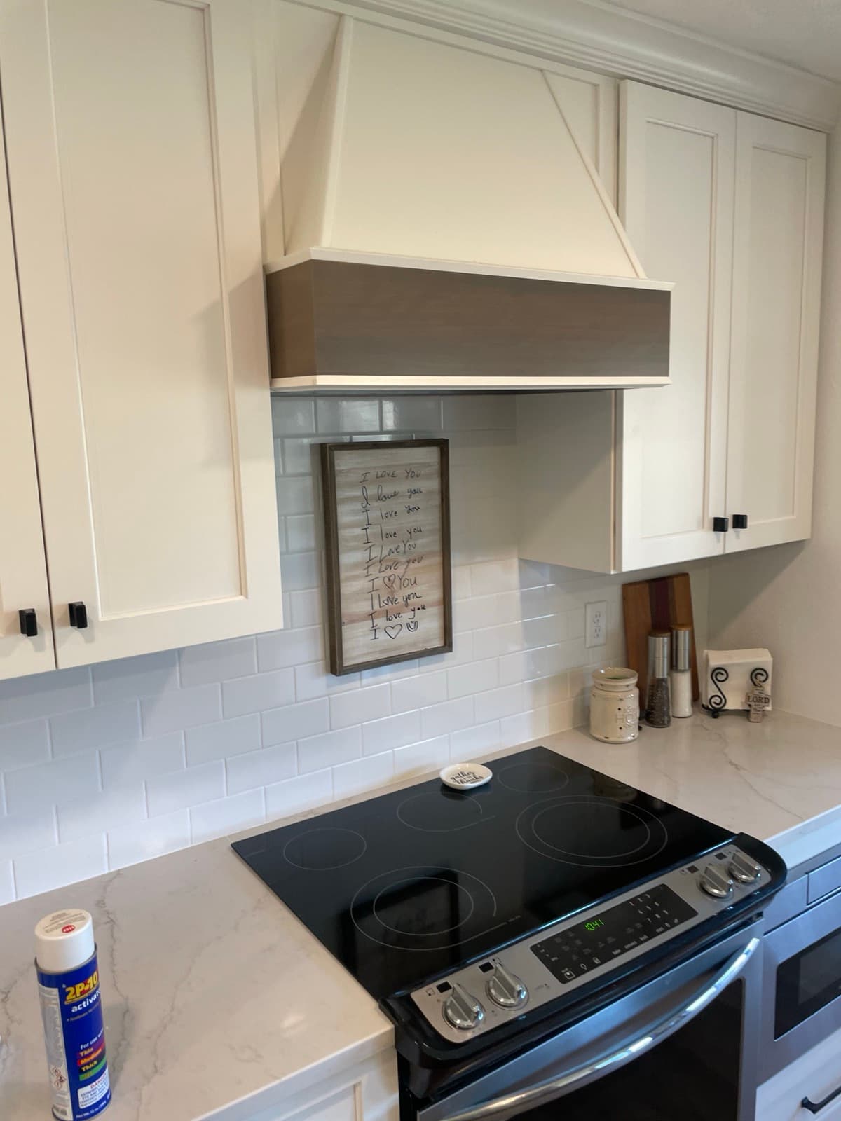 Kitchen remodel — custom cabinets, subway tile backsplash, and range hood